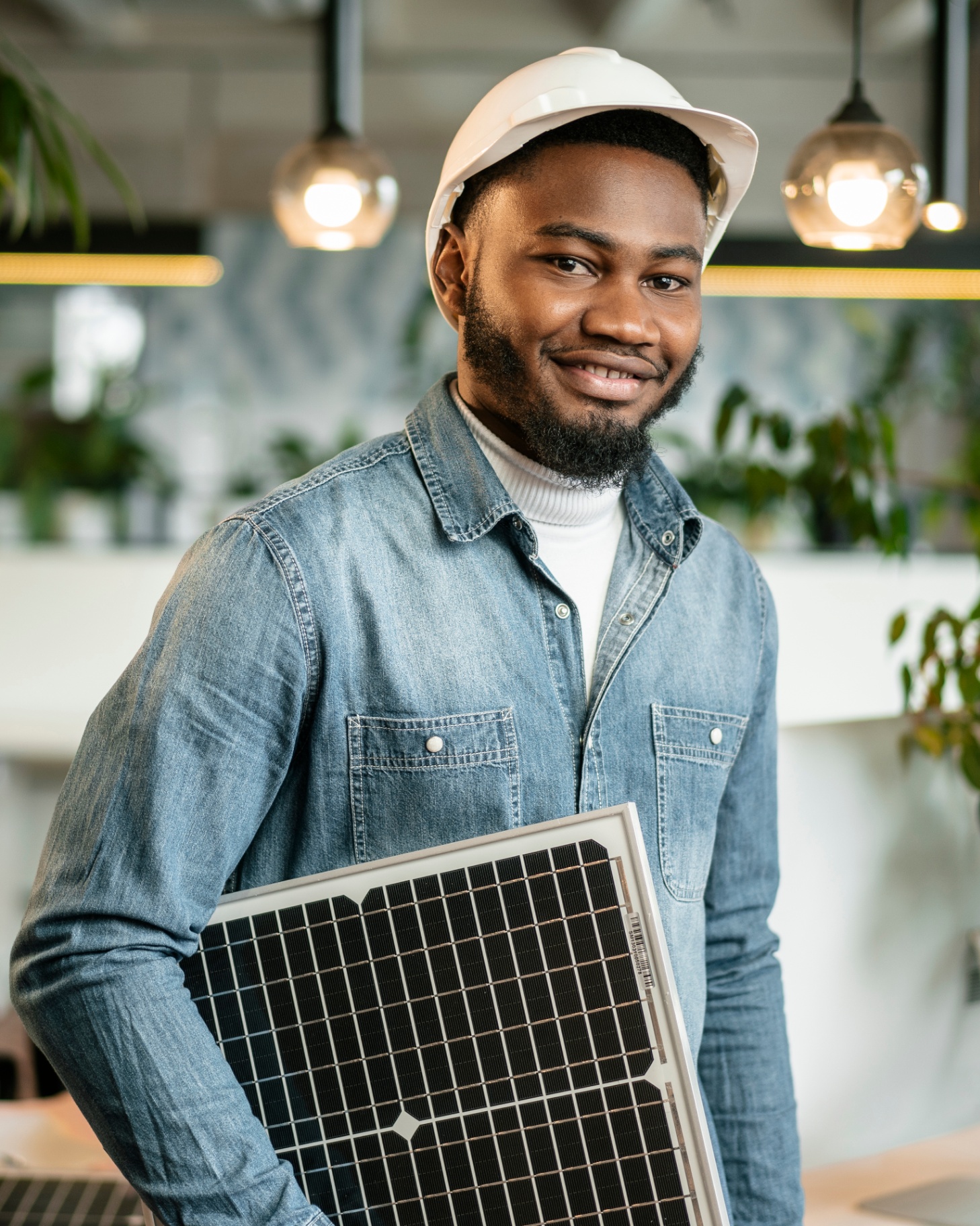 Verified Uwana solar installer holding a solar panel